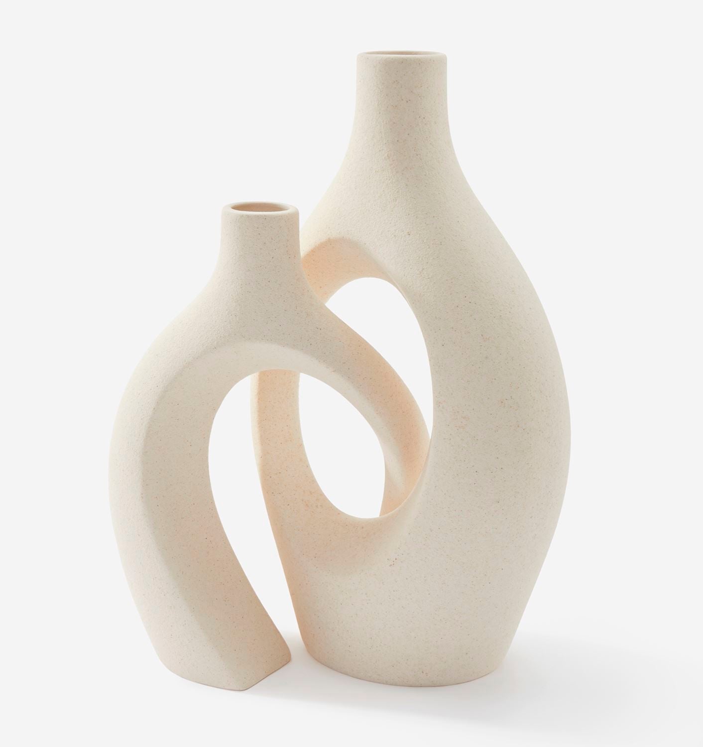Two cream-colored ceramic vases with a modern design on a white background