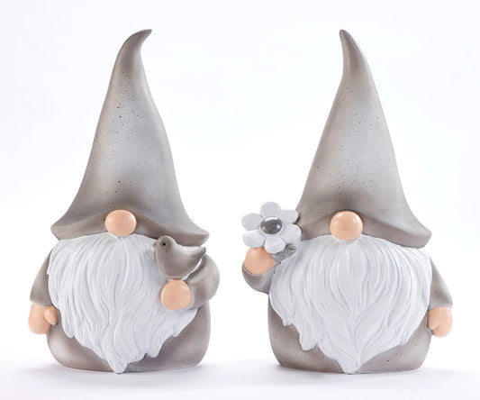 Two ceramic figurines of gnomes, one with a bird design and the other with a daisy design, both with pointed hats and beards.