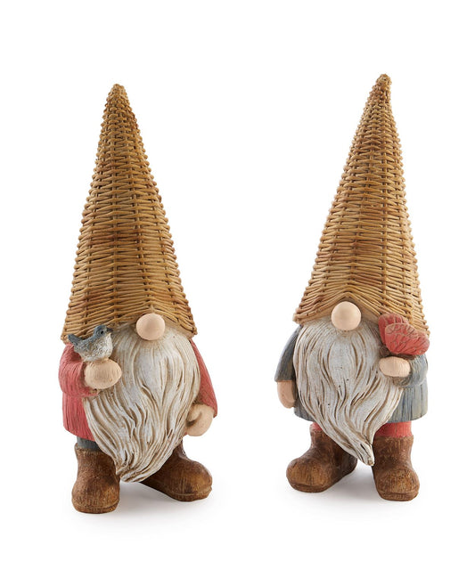 Two decorative gnomes, one with a butterfly-like pattern and the other resembling a bird, made of a wicker-like material with fabric details, painted in shades of blue, brown, and beige.