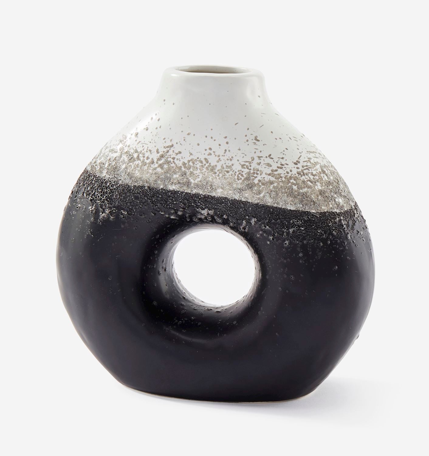 Cylindrical ceramic vase with black and white speckled design on a white background