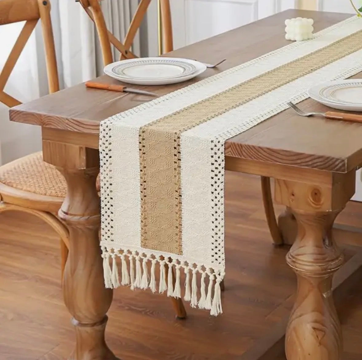 Wooden dining table with a beige and white patterned table runner
