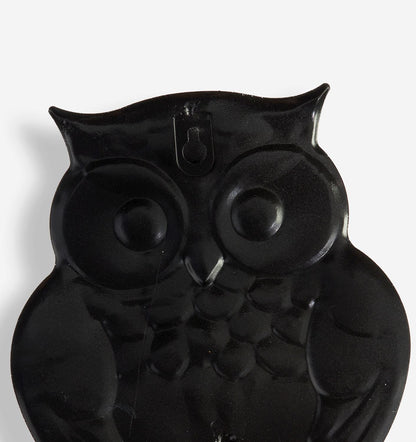 The Black Backing of owl-shaped object on a white background