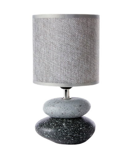 A grey and black table lamp with a base designed to resemble stacked stones